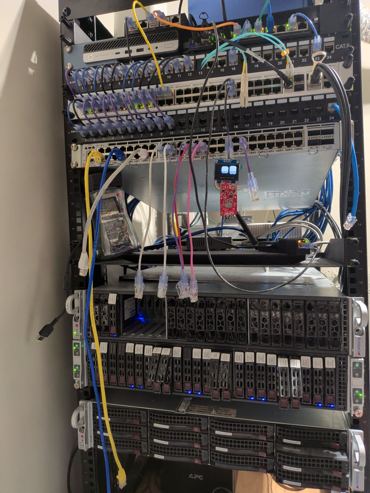 The rack: switch and patch panel up top, the 2028TP-HC with all four node sleds below